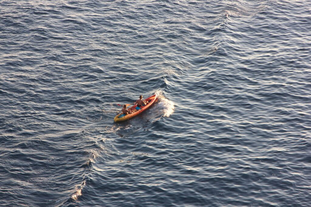 People kayaking in ocean